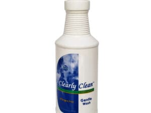 A bottle of cleaner is sitting on the floor.